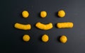 cheetos snack making morse code of SOS or three divide signs in black paper Royalty Free Stock Photo