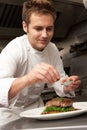 Chef Adding Seasoning To Dish In Restaurant Royalty Free Stock Photo
