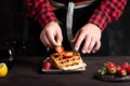 Chef adding strawberries on a waffle close up