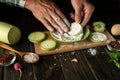 The chef adds flour to the zucchini before roasting with vegetables and an egg. Working environment on the kitchen table Royalty Free Stock Photo