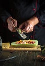 Chef adds onions to the marrow. The concept of cooking national stuffed squash or zucchini in the hotel kitchen. Free space for