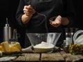 The chef adds salt to a large glass bowl of flour. Levitation. Ingredients for making Italian focaccia bread, pizza, pie, pasta. Royalty Free Stock Photo