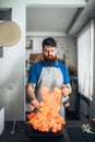 Chef against frying pan with fire, fish cooking Royalty Free Stock Photo