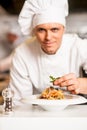 Chef arranging pasta salad in a white bowl Royalty Free Stock Photo