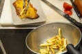 The chef assembling a plate of veal milanesa with a garnish