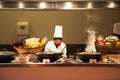 Chef and assistant Chefs cooking and prepared buffet food at restaurant in night time in Bangkok, Thailand