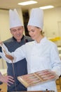 chef and assistant prepare chocolate fill for pastries Royalty Free Stock Photo