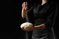 Chef, baker prepares bread. Flour freezing flour in the air. Advertising photo, on a black background, for design. Horizontal