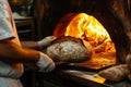 chef bakes bread in a woodfired oven Royalty Free Stock Photo
