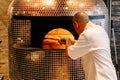 Chef Baking Caprese Bianca Pizza inside wood burning pizza oven Royalty Free Stock Photo