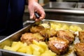 chef basting pork chops with apple sauce