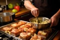 chef basting pork chops with apple sauce