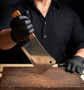 Chef in a black shirt and black latex gloves holds a large kitchen knife Royalty Free Stock Photo