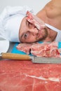 Chef bodybuilder preparing large chunks of raw meat. natural proteins