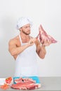 Chef bodybuilder preparing large chunks of raw meat. natural proteins