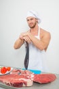 Chef bodybuilder preparing large chunks of raw meat. natural proteins