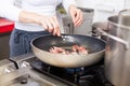 Chef or braising meat in a frying pan Royalty Free Stock Photo