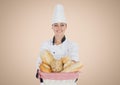 Chef with bread against cream background Royalty Free Stock Photo