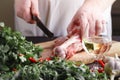 Chef Butcher cutting lamb meat with knife on kitchen, cooking proteine food