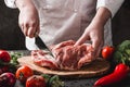 Chef Butcher cutting pork meat with knife on kitchen, cooking food. Royalty Free Stock Photo