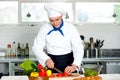 Chef carefully chopping vegetables