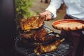 The chef checks the meat on the grill. Grilled golden ribs steaks, delicious food