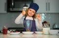 Chef child cooking. Child making tasty delicious. little boy in chef hat and an apron cooking in the kitchen. Kid boy in Royalty Free Stock Photo