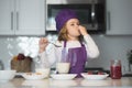 Chef child cooking healthy meal and dinner preparation. Chef child in apron and chef hat cooking at kitchen. Healthy Royalty Free Stock Photo