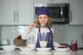 Chef child cooking healthy meal and dinner preparation. Child making tasty delicious. little boy in chef hat and an Royalty Free Stock Photo