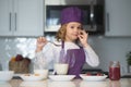 Chef child cooking healthy meal and dinner preparation. Kid making tasty delicious. little boy in chef hat and an apron Royalty Free Stock Photo
