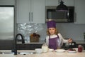 Chef child cooking. Chef kid boy in apron and chef hat cooking at kitchen. Healthy food. Royalty Free Stock Photo