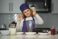 Chef child cooking. Child making tasty delicious. little boy in chef hat and an apron cooking in the kitchen. Kid boy in Royalty Free Stock Photo