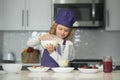 Chef child prepared ingredients. Kid making tasty delicious. little boy in chef hat and an apron cooking in the kitchen. Royalty Free Stock Photo