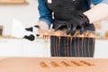 Chef or chocolatier making sweet chocolates home on background of kitchen