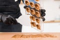 Chef or chocolatier making sweet chocolates home on background of kitchen