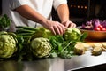 chef chopping artichokes for dinner prep