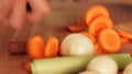 Chef chopping carrot using santoku kitchen knife