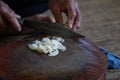 The chef is chopping the galangal, meat and bone on the chopping board to cook. Royalty Free Stock Photo