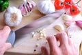 Chef chopping garlic on a cutting table