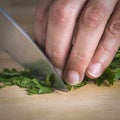 Chef chopping parsley leaves