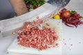 Chef is chopping the raw beef on cutting board with knife to cook in the kitchen, minced beef. Kebab restaurant, kebab preparation