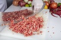 Chef is chopping the raw beef on cutting board with knife to cook in the kitchen, minced beef. Kebab restaurant, kebab preparation