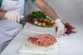 Chef is chopping the raw beef on cutting board with knife to cook in the kitchen, minced beef. Kebab restaurant, kebab preparation