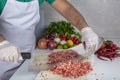 Chef is chopping the raw beef on cutting board with knife to cook in the kitchen, minced beef. Kebab restaurant, kebab preparation