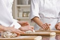 Chef co-workers kneading dough in kitchen Royalty Free Stock Photo