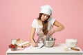 Chef cook or baker in white t-shirt, toque chefs hat cooking cake or cupcake at table, talking on cellphone, take an