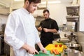 Chef and cook cooking food at restaurant kitchen Royalty Free Stock Photo