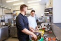 Chef and cook cooking food at restaurant kitchen Royalty Free Stock Photo