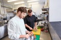 Chef and cook cooking food at restaurant kitchen Royalty Free Stock Photo