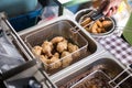 Chef cook crispy chicken in the deep fat fryer in a restaurant Royalty Free Stock Photo